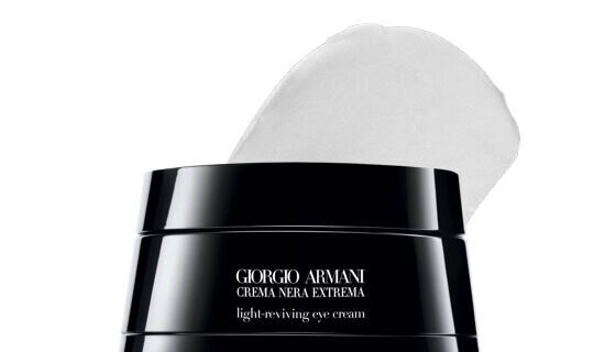 Ein schwarzer Tiegel mit der Bezeichnung „Giorgio Armani Crema Nera Extrema Light-Reviving Eye Cream“ und einem weißen Cremetupfer oben drauf.
