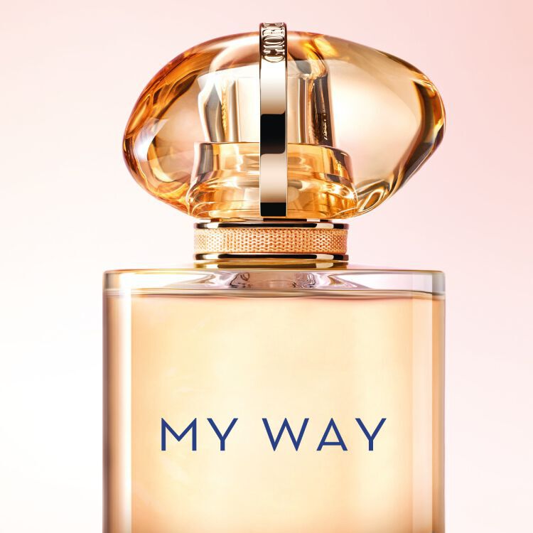 Armani My Way Sunny Vanila fragrance bottle with a gold-toned cap and soft pink background, highlighting its elegant and luxurious design.