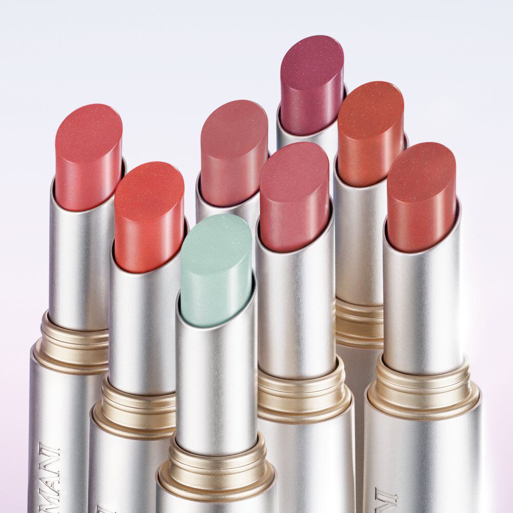 Armani Prisma Flash lipstick collection displayed upright, featuring a variety of vibrant and pastel shades in sleek metallic tubes.