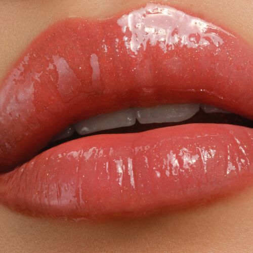Armani Prisma Flash 20 Solar Flash lipstick on lips, highlighting a vibrant coral-red shade with intense gloss.