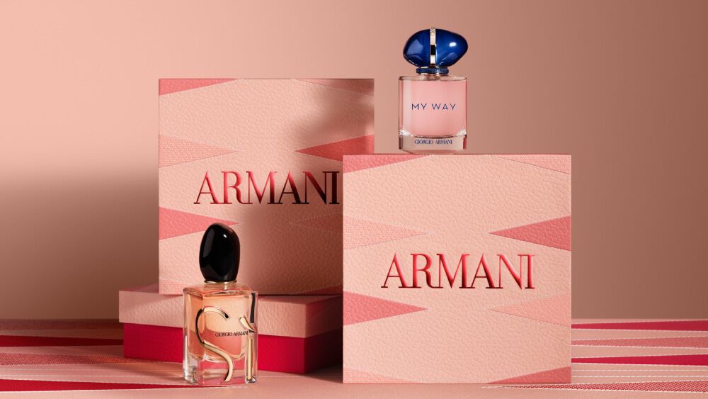 Armani gift sets featuring Si and My Way Eau de Parfum bottles, displayed with elegant pink and red Armani Mother's Day boxes on a matching geometric background.